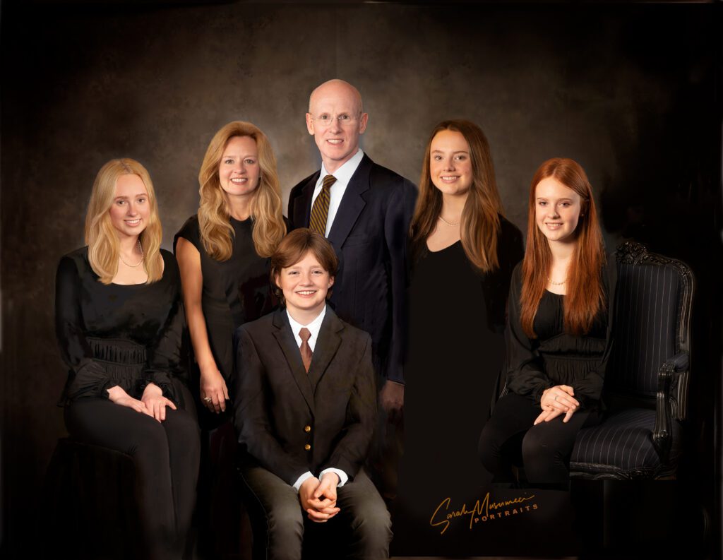 Family portrait with a brown background.