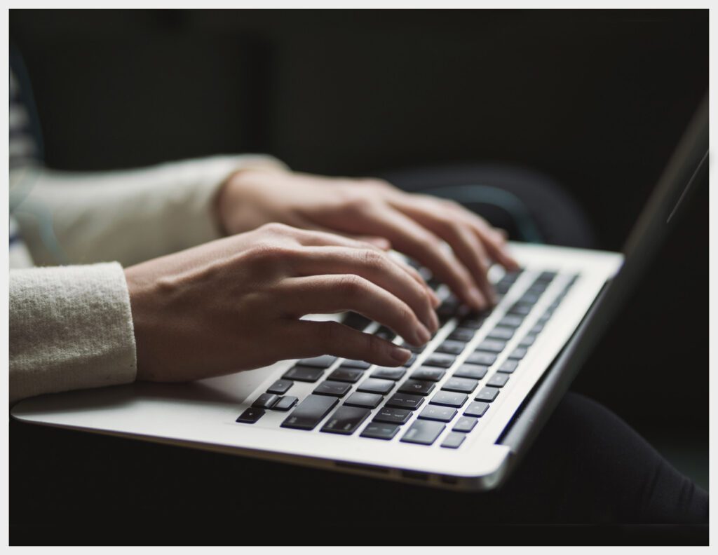 A photo of hands using a laptop - Welcome to my Blog by Sarah Musumeci Fine Art Portraiture