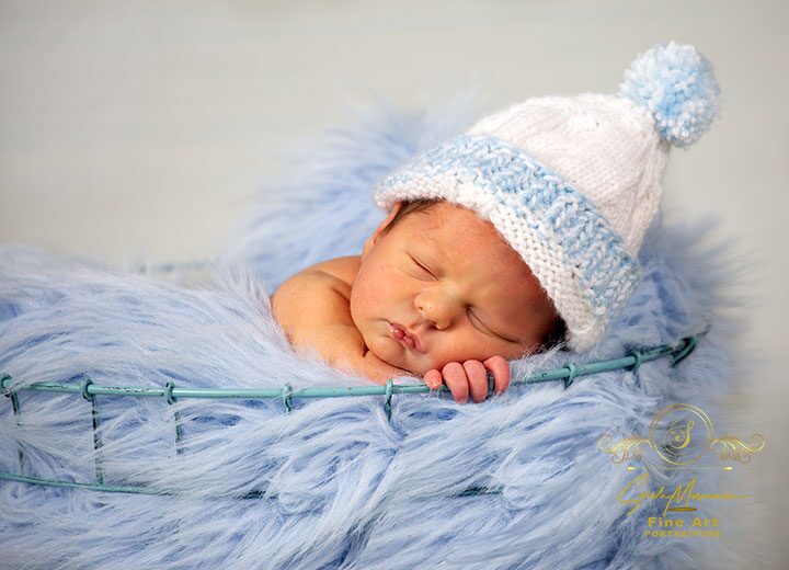 Newborn baby in blue basket by Sarah Musumeci Fine Art Portraiture
