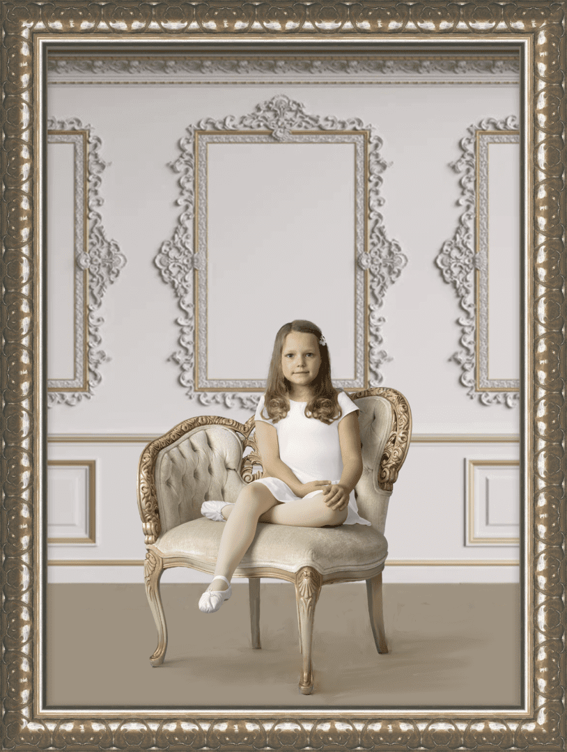 Young girl in white dress sitting in a chair.